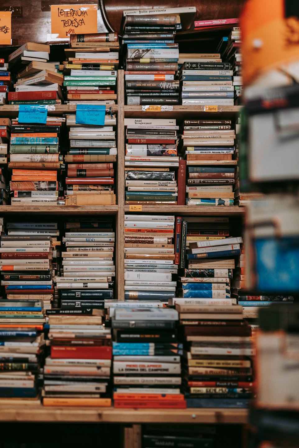 Wooden bookshelf packed with old and new books.